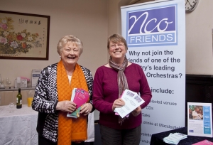 Two Friends of the Northern Chamber Orchestra holding fleyrs