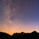 A starry night view over mountains.